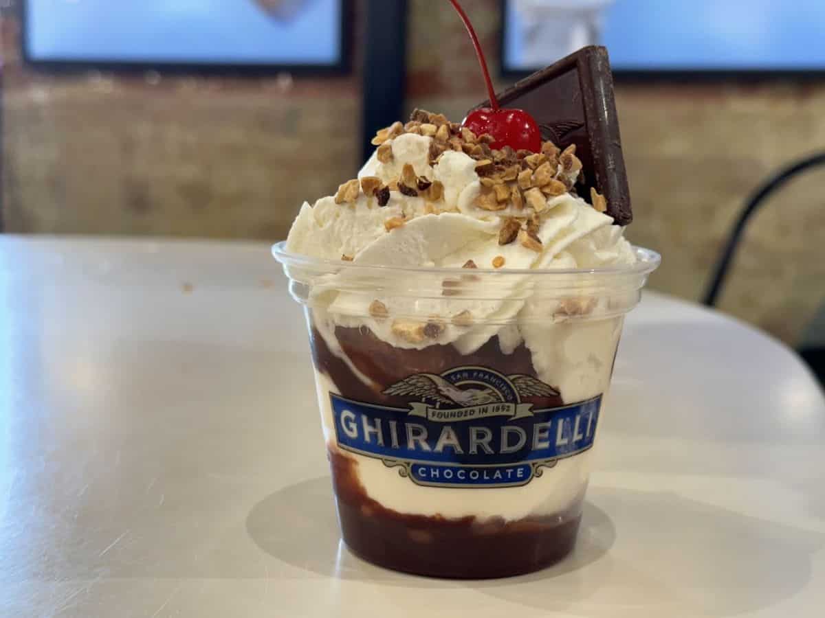 A large hot fudge sundae topped with whipped cream and chocolate at Ghirardelli Square, included among the Best Spots to eat in San Francisco.