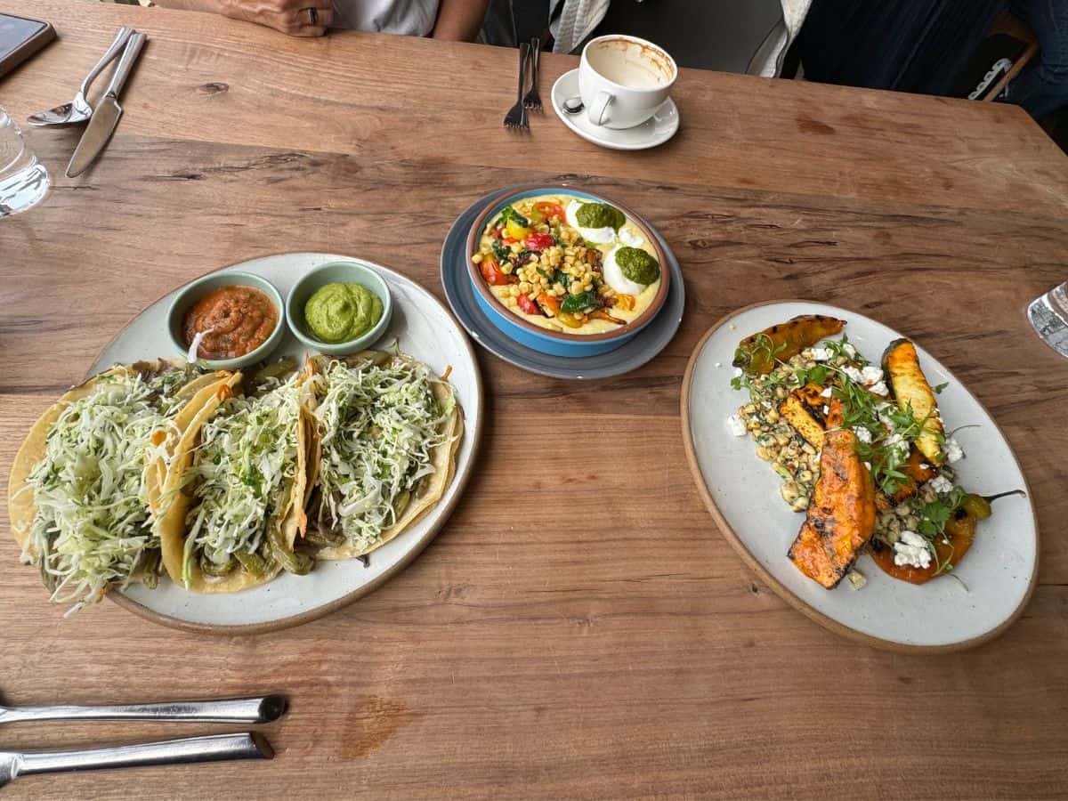 Colorful vegetarian dishes and tacos at Greens Restaurant with fresh toppings and sauces, known as one of the Best Spots to eat in San Francisco.