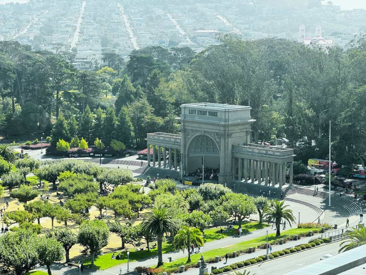 Chinatown Gateway in San Francisco surrounded by lush greenery and park visitors.