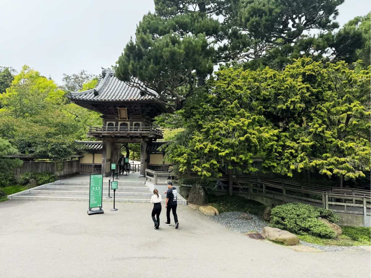 Traditional Japanese temple entrance surrounded by lush greenery in Bae Area and Beyond.